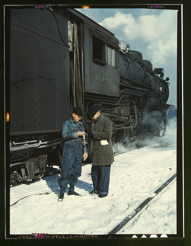 Conductor George E. Burton and engineer J.W. Edwards comparing time before pulling out of Corwith railroad yard for Chillicothe, Illinois; Chicago, Ill.jpg