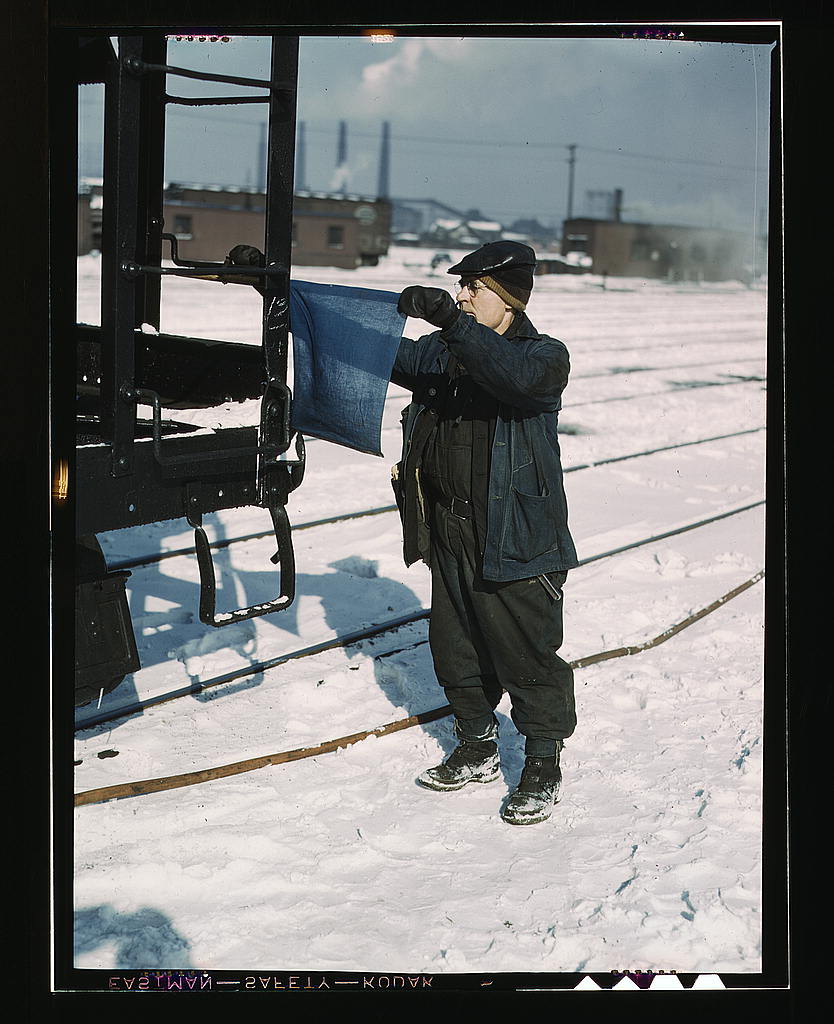 John Paulinski, car inspector, blue flagging a train for inspection, at Corwith yard, Santa Fe RR trip, Chicago, Ill.jpg