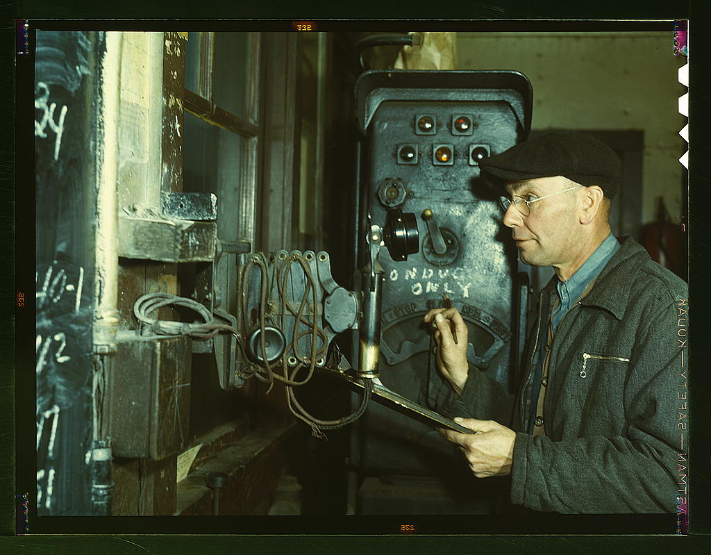 Hump master in a Chicago and Northwestern railroad yard operating a signal switch system which extends the length of the hump track.jpg