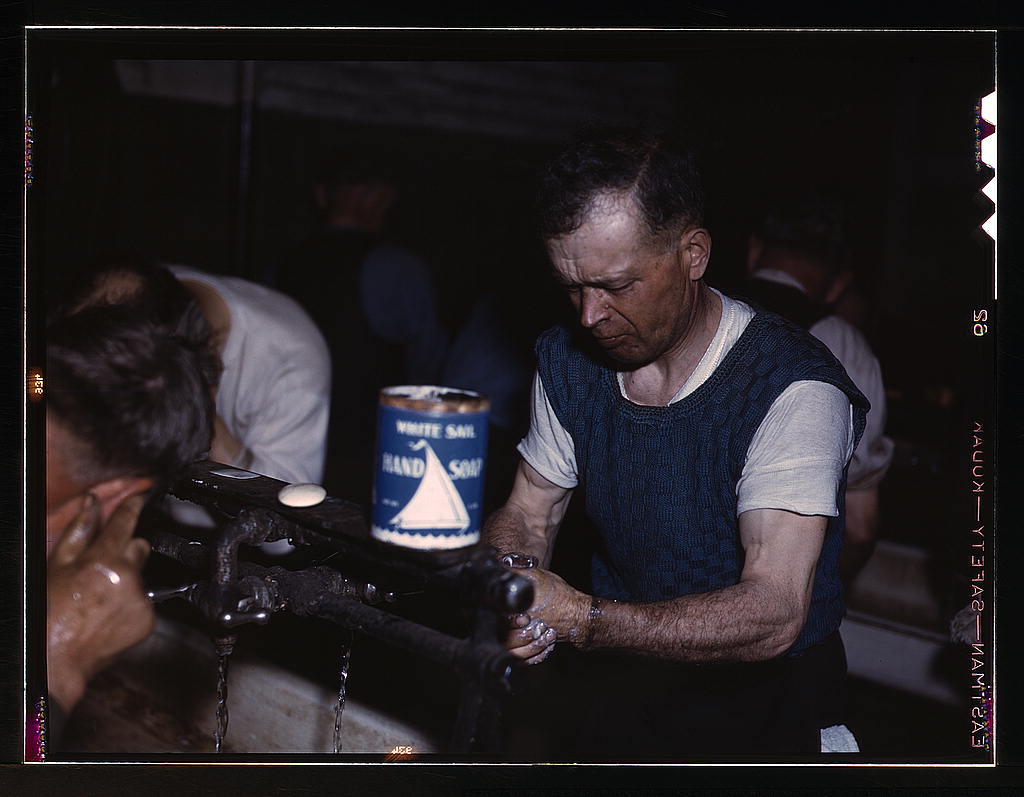 Joseph Klesken washing up after a day's work at the rip tracks at Proviso yards of the C & NW RR., Chicago, Ill..1942.jpg