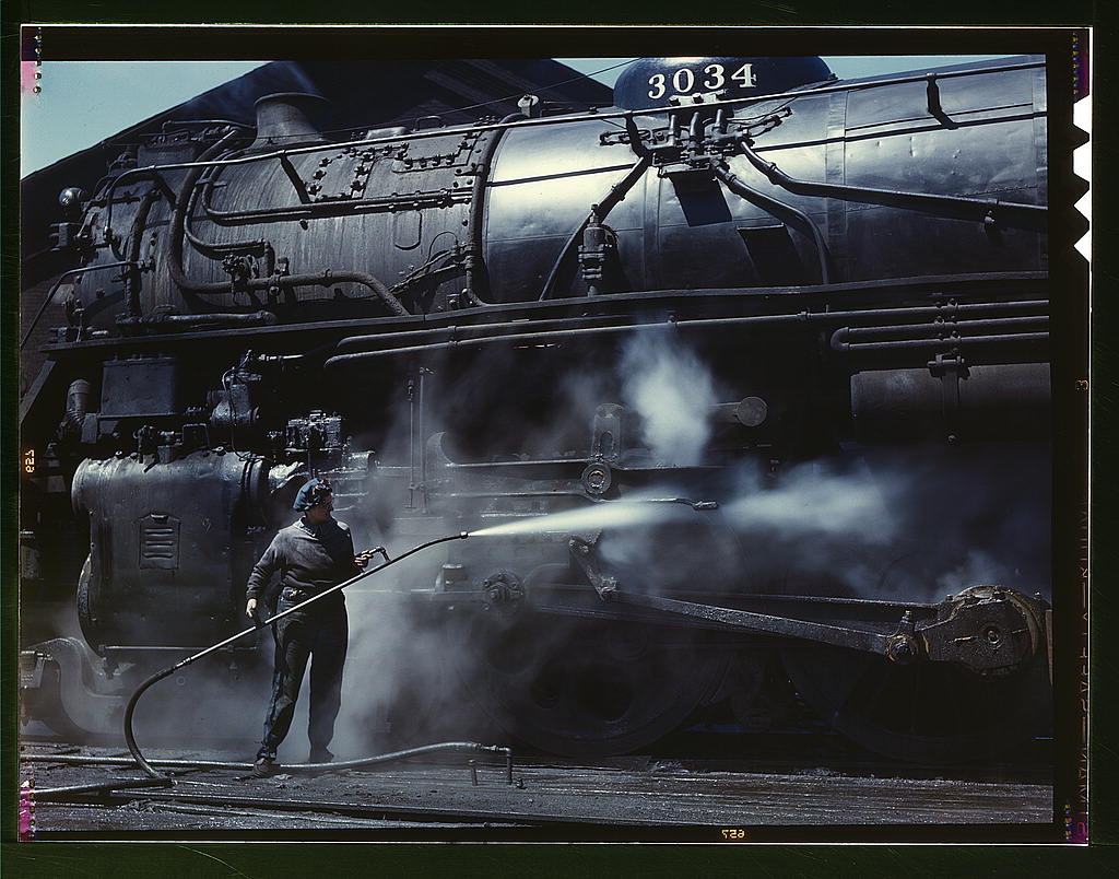 Mrs. Viola Sievers, one of the wipers at the roundhouse giving a giant H class locomotive a bath of live steam, Clinton, Iowa.1943.jpg